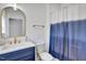 Chic bathroom with a blue vanity, modern fixtures, and a stylish shower curtain at 500 Spruce St, Durham, NC 27703