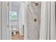 Bright bathroom featuring a marble tiled shower with brass fixtures at 500 Spruce St, Durham, NC 27703