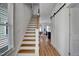 Bright entryway with wood floors, staircase, and a sliding barn door at 500 Spruce St, Durham, NC 27703