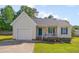 A single-story home with a one-car garage and front porch provides inviting curb appeal at 5316 Tanglewood Pine Ln, Raleigh, NC 27610