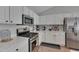 Stylish kitchen features stainless steel appliances, white cabinets, and quartz countertops at 5316 Tanglewood Pine Ln, Raleigh, NC 27610