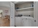 Functional laundry room featuring a modern washer and dryer and shelving for storage at 5316 Tanglewood Pine Ln, Raleigh, NC 27610