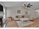 Cozy living room showcasing a ceiling fan, fireplace, and comfortable seating arrangement at 5316 Tanglewood Pine Ln, Raleigh, NC 27610