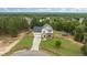 Another aerial view of home with a long drive and fenced backyard surrounded by mature trees at 576 Prairie Ln, Lillington, NC 27546