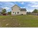 Back exterior showing a large yard with storage shed and fenced perimeter at 576 Prairie Ln, Lillington, NC 27546