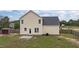 Back exterior view featuring a well-maintained lawn with a concrete patio at 576 Prairie Ln, Lillington, NC 27546
