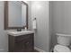 Well-lit powder room with a modern vanity, bronze fixtures, and a neutral color scheme at 576 Prairie Ln, Lillington, NC 27546