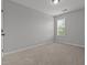 Cozy bedroom with neutral carpet and walls with one window at 576 Prairie Ln, Lillington, NC 27546