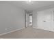Clean, cozy bedroom with neutral carpet, walls, and door into the hallway at 576 Prairie Ln, Lillington, NC 27546