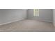 Bright bedroom featuring neutral walls, plush carpet, and a window at 576 Prairie Ln, Lillington, NC 27546