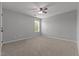 Spacious bedroom with neutral carpet and a ceiling fan at 576 Prairie Ln, Lillington, NC 27546