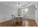 Bright dining room with hardwood floors, a decorative chandelier, and wainscoting at 576 Prairie Ln, Lillington, NC 27546