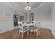 Elegant dining room featuring hardwood floors, wainscoting, and a decorative light fixture at 576 Prairie Ln, Lillington, NC 27546