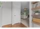 Inviting entryway featuring wood floors, shelving, and a view into the living room with a fireplace at 576 Prairie Ln, Lillington, NC 27546