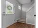 Inviting entryway with hardwood floors, a white front door, and a staircase at 576 Prairie Ln, Lillington, NC 27546