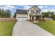 Charming two-story home with a well-manicured front lawn and an attached two-car garage at 576 Prairie Ln, Lillington, NC 27546