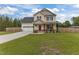 Charming two-story home with a well-manicured front lawn and an attached two-car garage at 576 Prairie Ln, Lillington, NC 27546