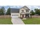Beautiful two-story house featuring a well-manicured lawn and long driveway at 576 Prairie Ln, Lillington, NC 27546