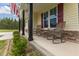Inviting front porch with rocking chairs and stone accents. Great for relaxing outdoors at 576 Prairie Ln, Lillington, NC 27546