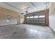 Spacious two-car garage with concrete flooring, white door, and overhead lighting at 576 Prairie Ln, Lillington, NC 27546