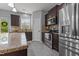 Well-lit kitchen featuring stainless steel appliances, granite countertops, and dark wood cabinetry at 576 Prairie Ln, Lillington, NC 27546