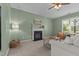 Relaxing living room featuring a fireplace, comfortable seating, and natural light from a nearby window at 576 Prairie Ln, Lillington, NC 27546