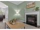 Elegant living room with a decorative fireplace, stylish decor, and an open view into the adjacent kitchen at 576 Prairie Ln, Lillington, NC 27546