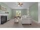 Bright living room with neutral tones, a fireplace, comfortable seating, and an open design at 576 Prairie Ln, Lillington, NC 27546