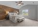 Inviting bedroom with wood accent wall, neutral carpet, and ample natural light from the window at 576 Prairie Ln, Lillington, NC 27546