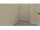 Empty walk-in closet with wire shelving and neutral carpet at 576 Prairie Ln, Lillington, NC 27546