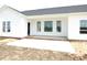 Covered back porch area with white siding, a brick foundation, and large windows at 614 Tart Town Rd, Dunn, NC 28334