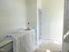 Bathroom vanity area with a door leading to a private toilet and shower at 614 Tart Town Rd, Dunn, NC 28334