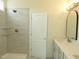 The bathroom features a tiled shower with a glass shelf and double sinks at 614 Tart Town Rd, Dunn, NC 28334