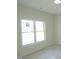 Bright bedroom featuring a large double hung window providing plenty of natural light and neutral paint at 614 Tart Town Rd, Dunn, NC 28334