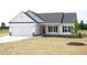 Charming single-story home boasts a white exterior, attached garage, and a well-manicured lawn at 614 Tart Town Rd, Dunn, NC 28334