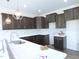 Kitchen displays dark wood cabinets, white countertops, recessed lighting and a subway tile backsplash at 614 Tart Town Rd, Dunn, NC 28334