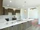 Lovely kitchen boasting granite countertops, dark wood cabinets, pendant lighting, and stainless steel sink at 614 Tart Town Rd, Dunn, NC 28334