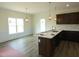 Kitchen and breakfast nook showcasing modern pendant lights, dark cabinets and luxury vinyl tile flooring at 614 Tart Town Rd, Dunn, NC 28334