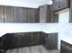 Lovely kitchen boasting granite countertops, dark wood cabinets, tiled backsplash, and stainless steel sink at 614 Tart Town Rd, Dunn, NC 28334