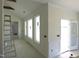 Bright living room featuring vaulted ceilings and large windows for natural light at 614 Tart Town Rd, Dunn, NC 28334