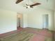 An open living room features vaulted ceilings with a ceiling fan and light-colored walls at 614 Tart Town Rd, Dunn, NC 28334