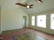 Large living room with wood beams, luxury vinyl tile flooring, many windows, and vaulted ceiling at 614 Tart Town Rd, Dunn, NC 28334