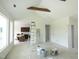 Open-concept living space leading to kitchen with vaulted ceilings and wooden beams at 614 Tart Town Rd, Dunn, NC 28334