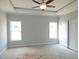 A Primary bedroom features two windows, a ceiling fan, and light-colored walls at 614 Tart Town Rd, Dunn, NC 28334