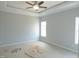 The primary bedroom features two windows, a ceiling fan, and light-colored walls at 614 Tart Town Rd, Dunn, NC 28334