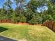 Large, well-maintained backyard featuring a wood fence and lush green grass at 617 Hiddenbrook Dr, Durham, NC 27703