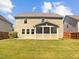 Spacious backyard featuring a lush green lawn and private screened-in porch at 617 Hiddenbrook Dr, Durham, NC 27703