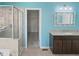 Bathroom featuring a glass shower, vanity with granite countertop, and a storage closet at 617 Hiddenbrook Dr, Durham, NC 27703