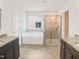 Luxurious bathroom featuring a soaking tub, separate shower, and double vanity with granite countertops at 617 Hiddenbrook Dr, Durham, NC 27703