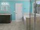 The bathroom includes a soaking tub, a glass enclosed shower, granite counters, and bright blue walls at 617 Hiddenbrook Dr, Durham, NC 27703